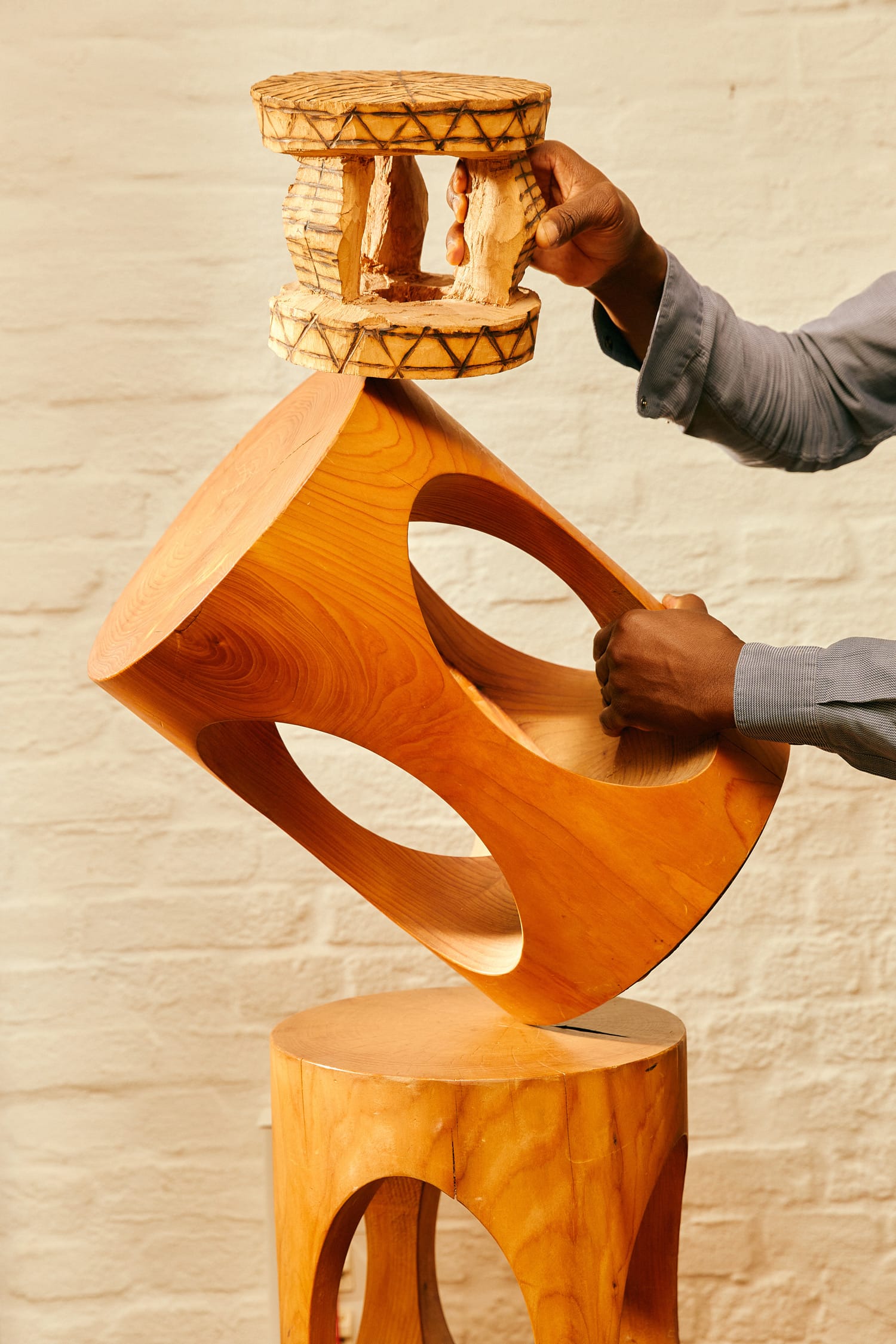 wooden sustainable stool being held by man